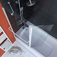 AURLANE - PARE BAIGNOIRE AVEC VOLET PIVOTANT 130x105cm PROFILE ALUMINIUM LAQUE BLANC ET VERRE TRANSPARENT - vignette
