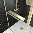 AURLANE - Paroi de Douche avec Volet Pivotant 90+40x200 cm - Porte-serviette + Etagère Finition Or Doré Brossé - vignette
