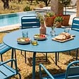 OVIALA - Ensemble table de jardin ronde et 6 fauteuils acier bleu pacific - Palavas - vignette
